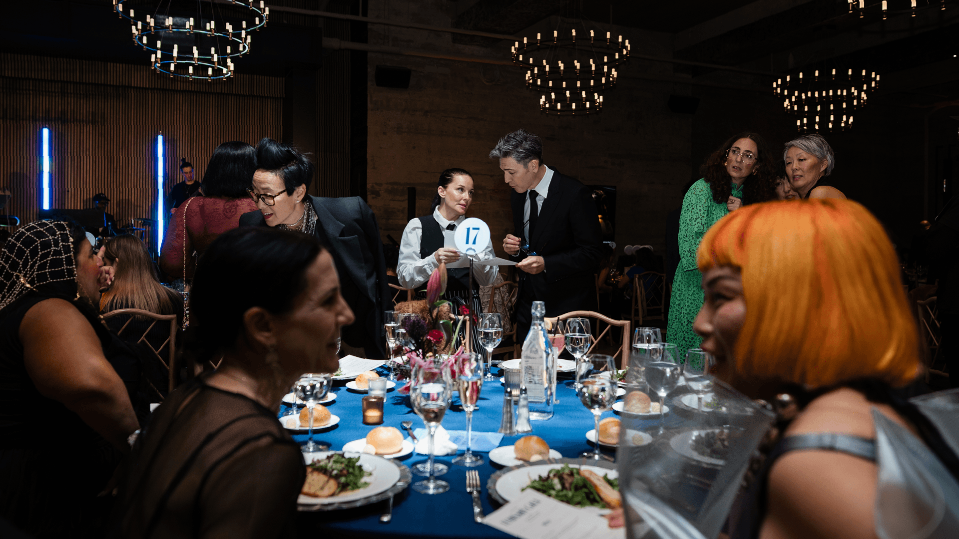 A photo of attendees at the the 2025 Luminary Gala. They are seated around a table in conversation.