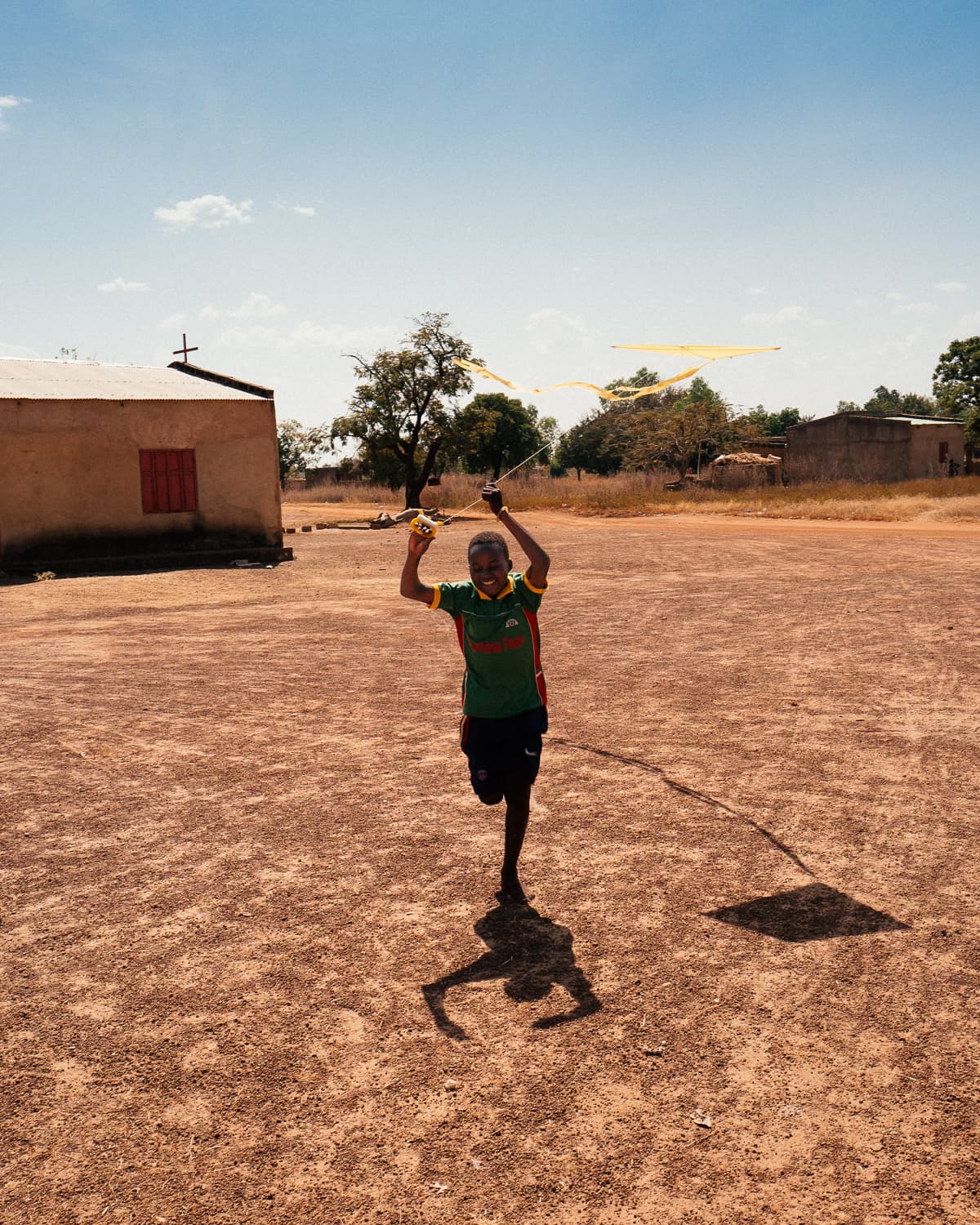 A still from "Bravo, Burkina!" shows a Black person running across a desert landscape.