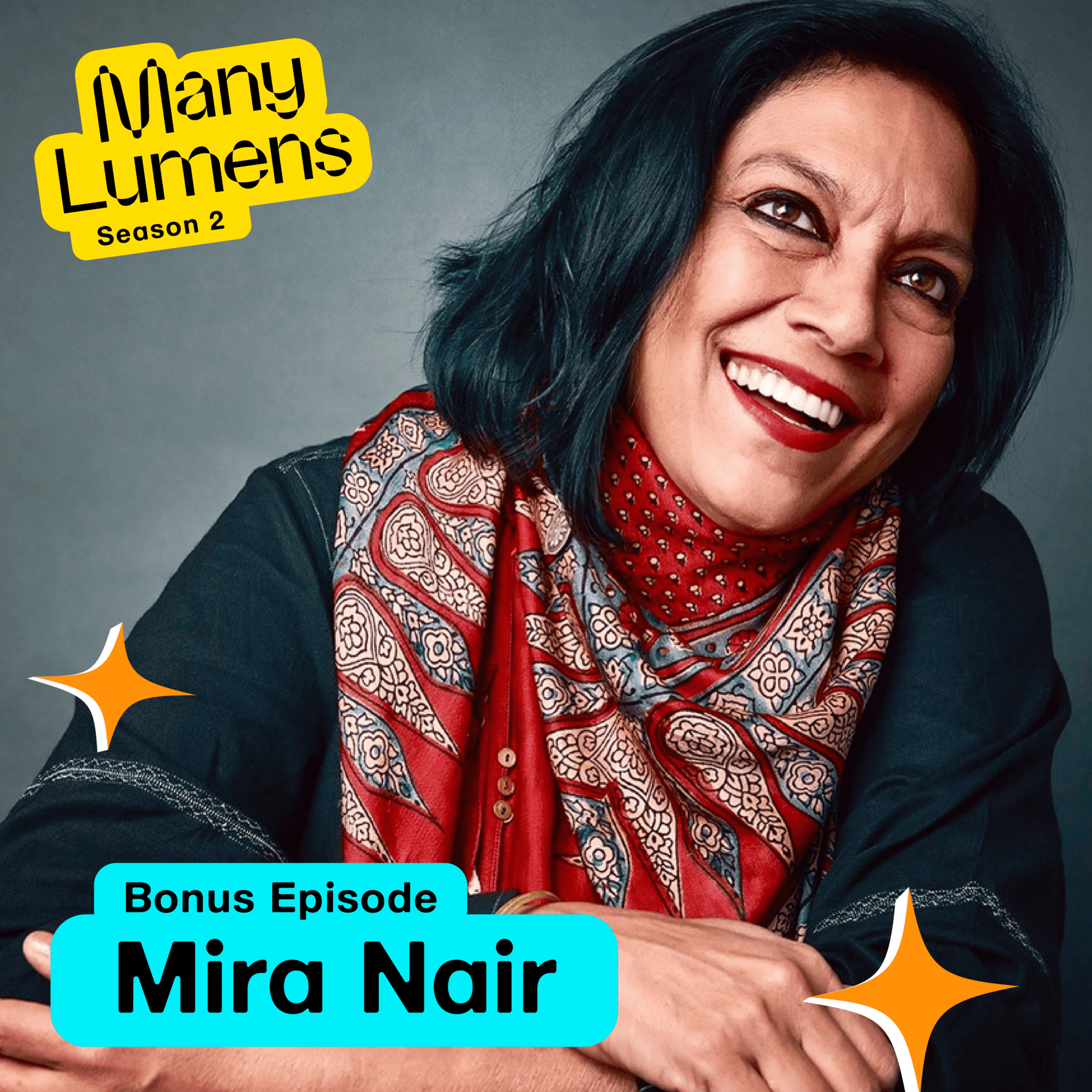Photo of Mira Nair, with graphics saying Many Lumens Bonus Episode, Mira Nair she is wearing a black shirt and a red scarf that matches her red lipstick. She has a big smile on her face and looks very happy.