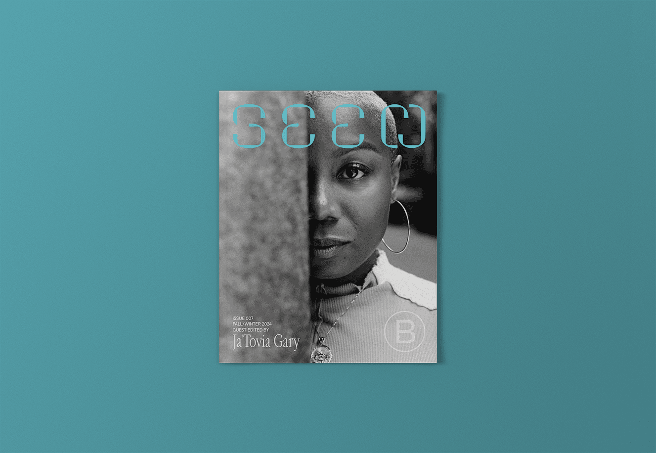 Seen Issue 007 cover image. It has a black-and-white image of Ja'Tovia Gary. She is looking straight ahead at the camera, half of her face is obscured by a wall of some sort. The Seen logo is at the top of the image in sky blue.