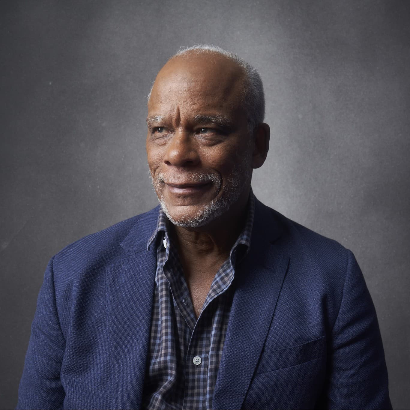 A photograph shows a portrait of Stanley Nelson.