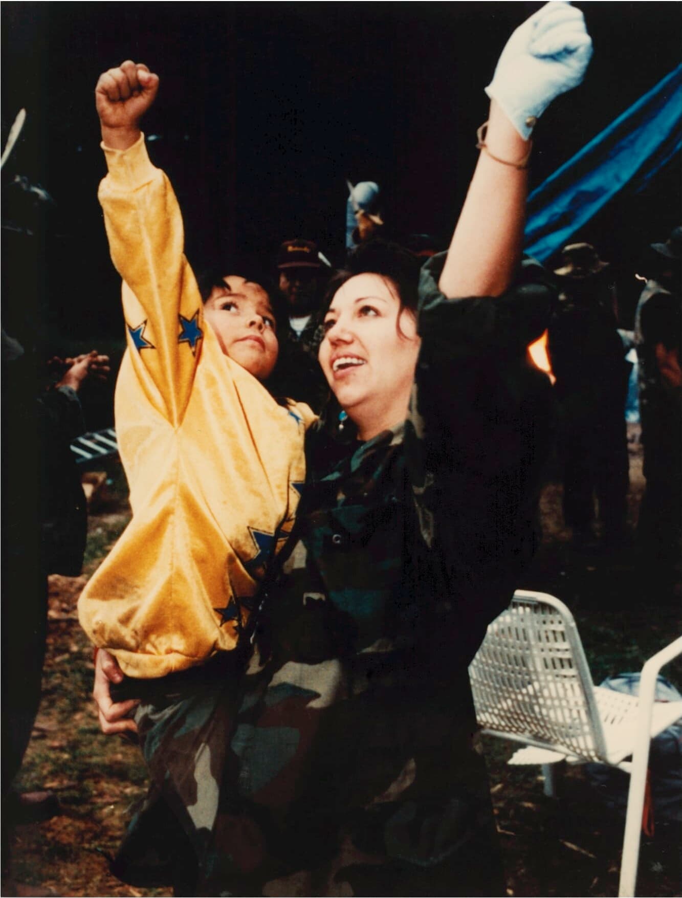 A woman and child put their fists in the air triumphantly in a still from “Kanehsatake: 270 Years of Resistance.”