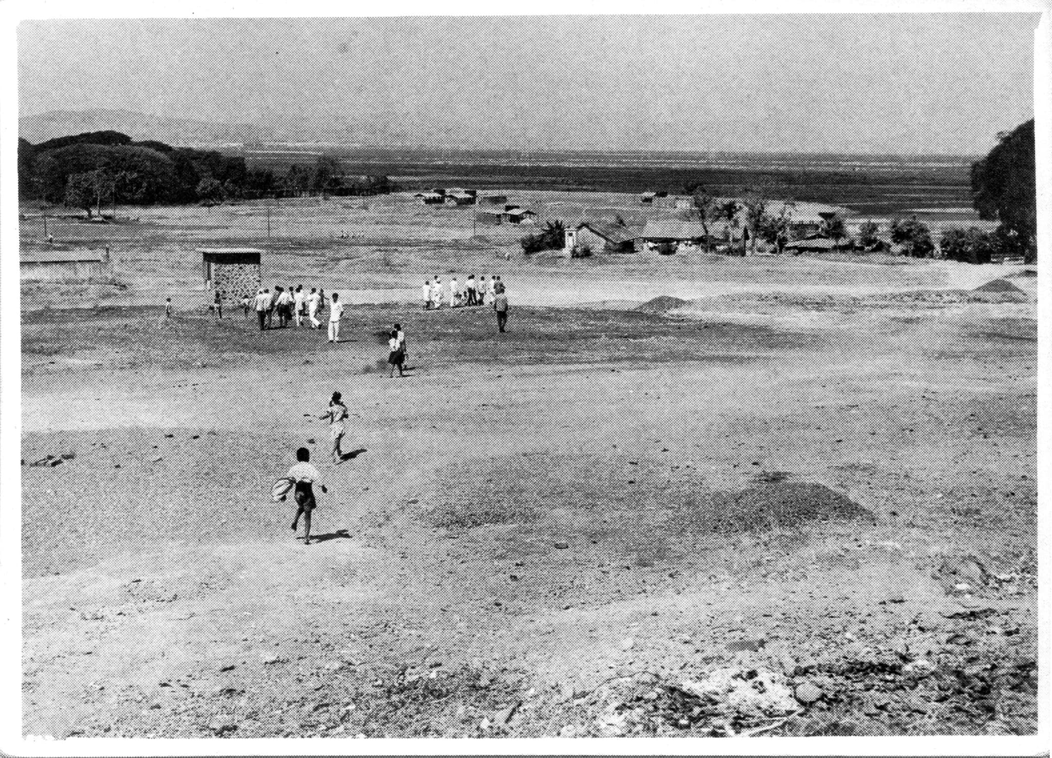 A black and white digital image of groups of people walking in a field